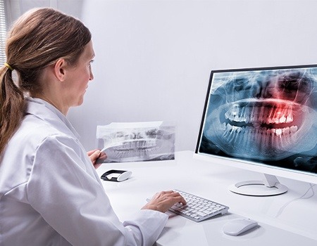 Dentist looking at dental x-rays