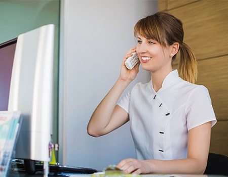 Woman at reception desk answering phone