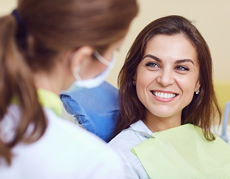 A woman smiling at the dentist