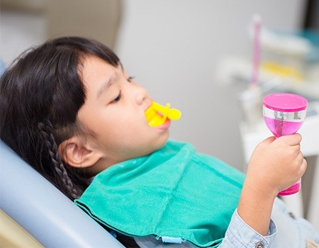 Child receiving fluoride treatment