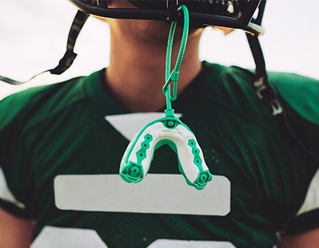 Mouthguard hanging from football helmet