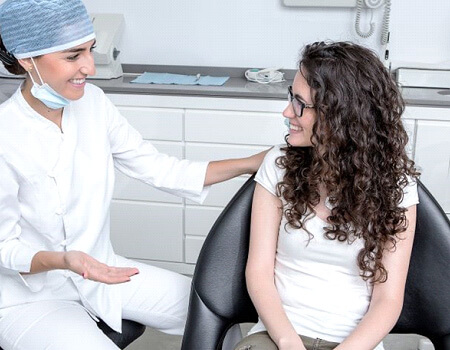 happy patient speaking with dental team member