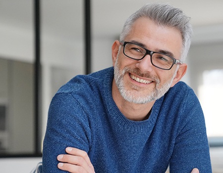 man smiling with arms crossed 