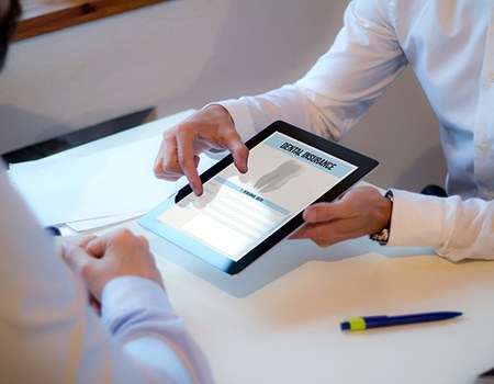 An insurance agent discussing dental insurance with a patient