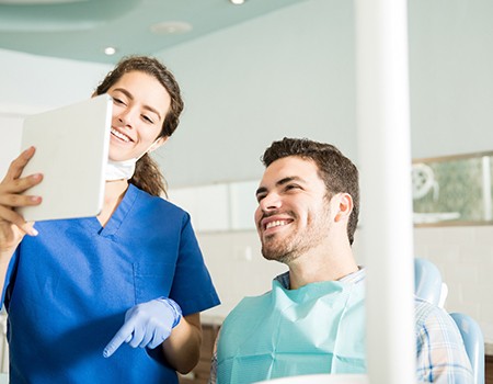 Dentist explains something to patient