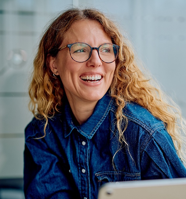 a smiling woman with glasses