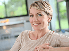 Woman smiling while sitting indoors