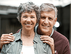 Older man and woman smiling together