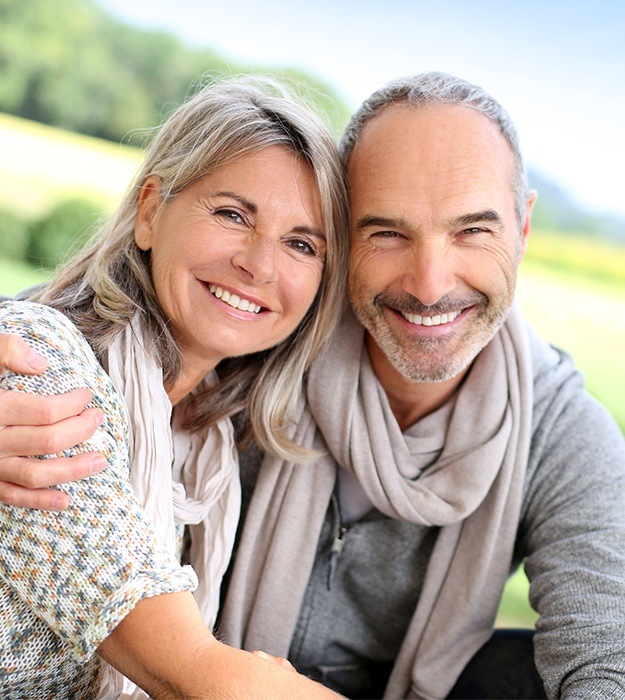 Older man and woman smiling together outdoors