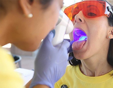 Woman receiving oral cancer screening