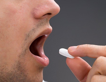 Man taking sedative pill