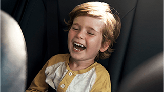 Child laughing in car