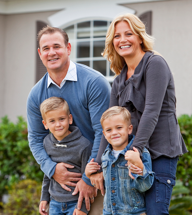 Smiling family of four outdoors