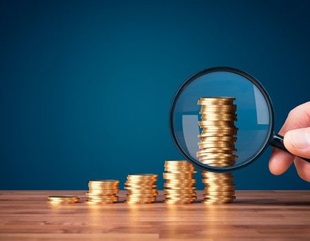 Stacks of coins examined with magnifying glass