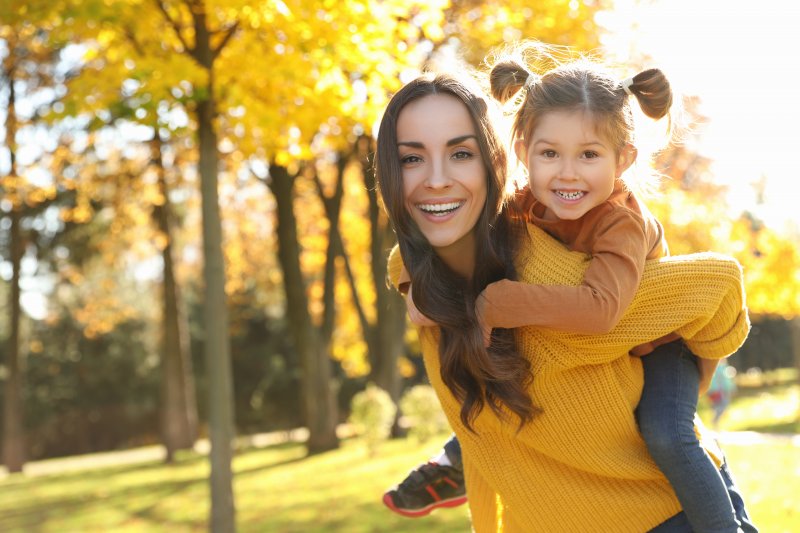 Mom and daughter smiling