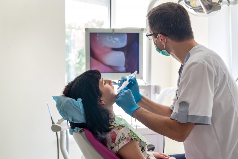 Dentist using an intraoral camera at dental appointment