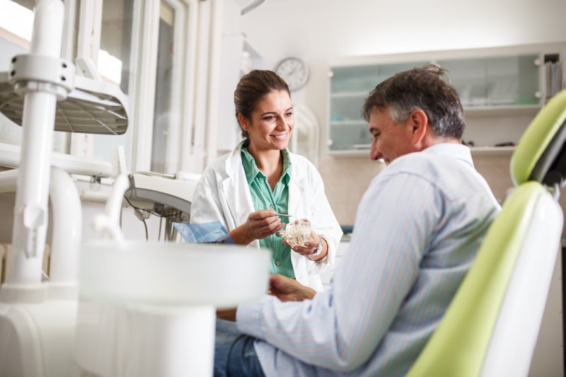 dentist and patient talking during dental implant consultation