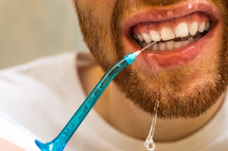 man using a Waterpik in Willow Grove