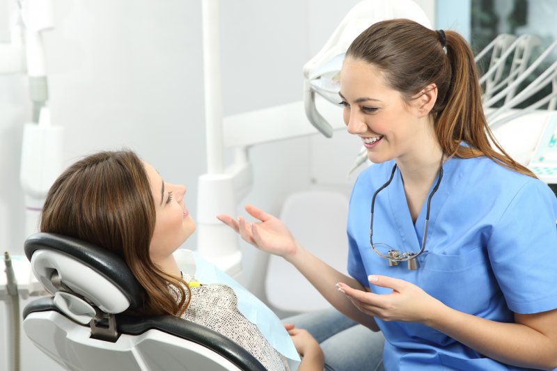 woman speaking with dentist about Invisalign benefits