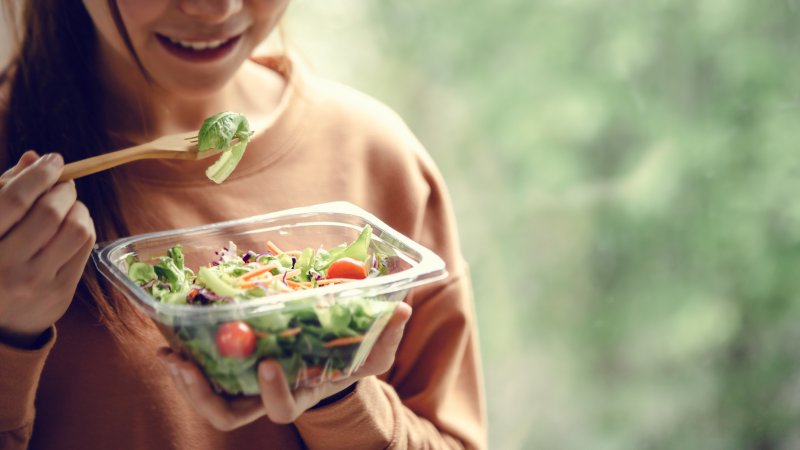 A woman eating a salad to help her metabolism in Willow Grove