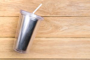 a tumbler with a drinking straw 