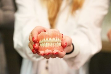 dentist holding model of dentures
