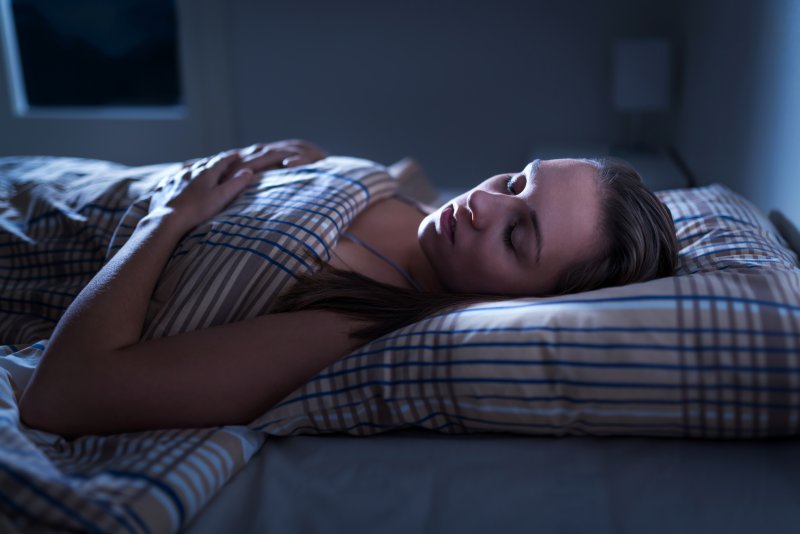 a woman asleep in her bed 